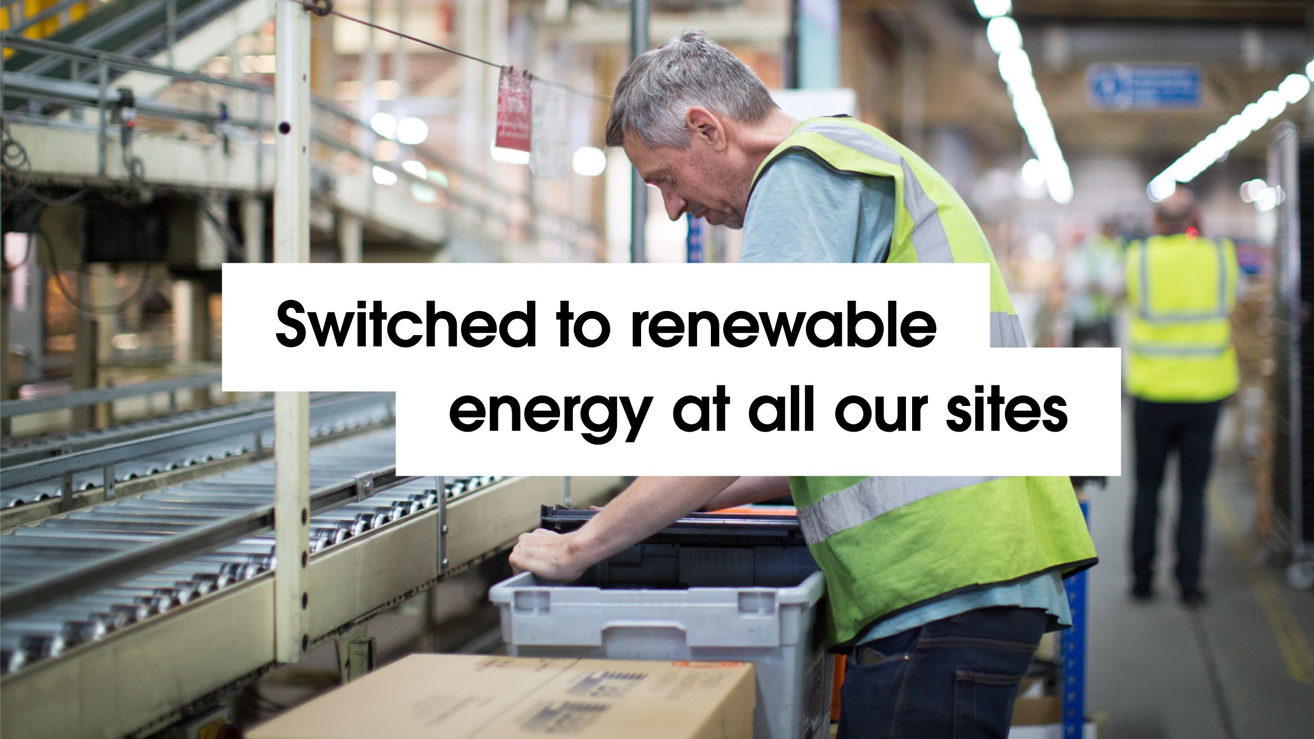 'Switched to renewable energy at all our sites' with background image of a Penguin Random House staff member in the warehouse.