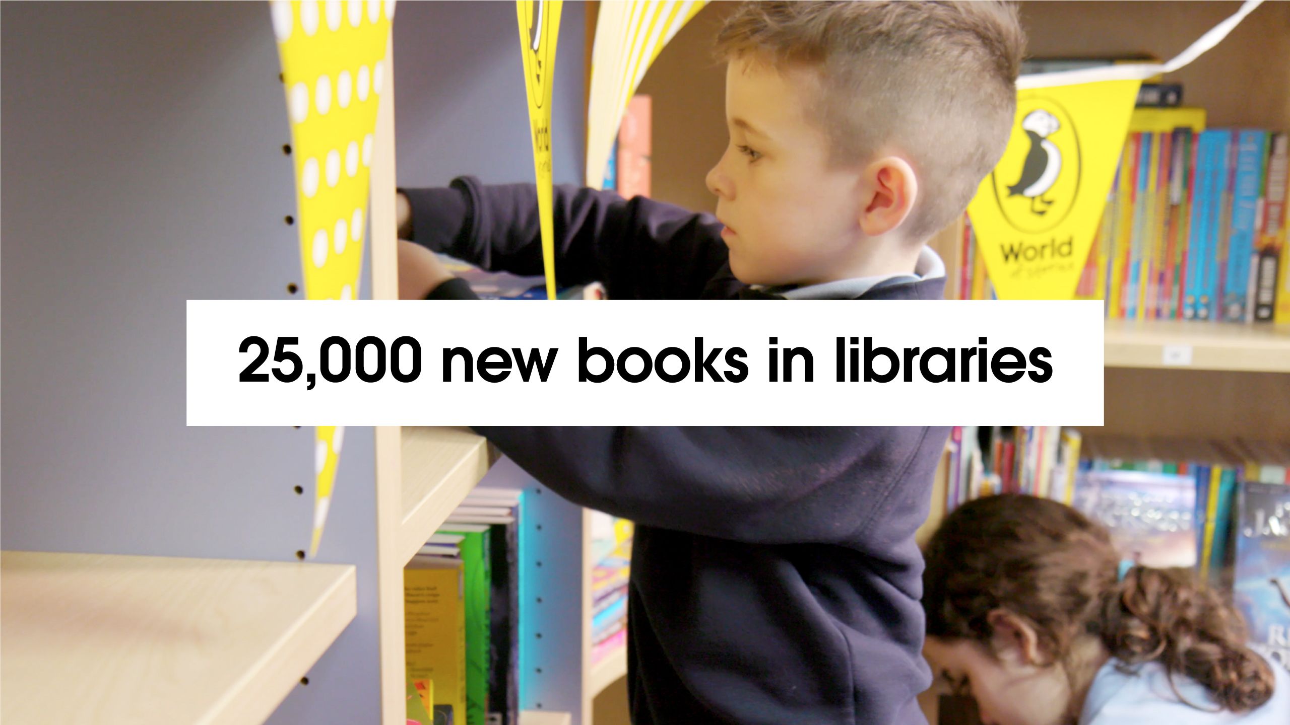 '25,000 new books in libraries' – with background of children in library as part of Puffin World of Stories